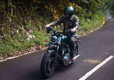 Man riding motorcycle on road