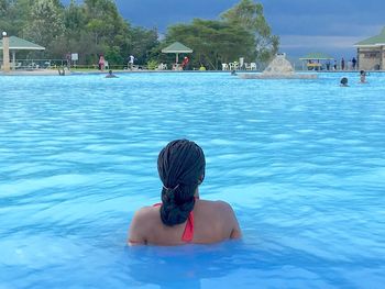 Rear view of woman in swimming pool