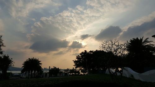 Scenic view of grassy field against cloudy sky