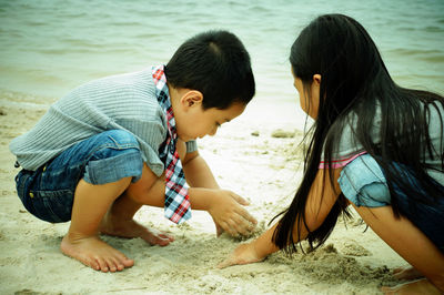 Rear view of friends on beach