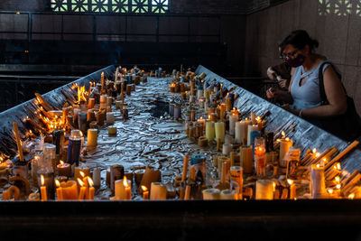 Panoramic view of man holding candles in temple