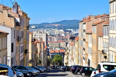 View of street amidst buildings in city