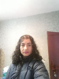 Portrait of smiling man against wall at home