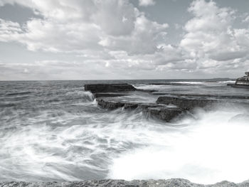 Scenic view of sea against cloudy sky