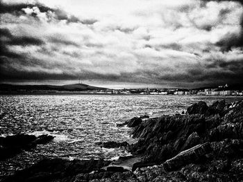 Scenic view of sea against cloudy sky