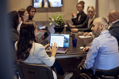 Multiracial business professionals discussing during conference call in board room