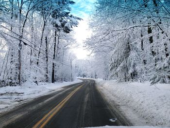 Road passing through snow covered landscape