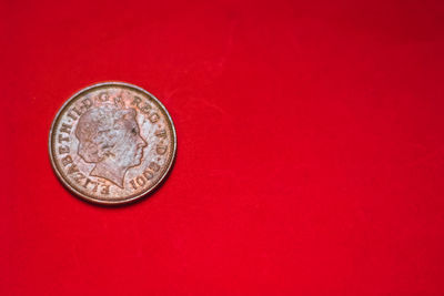 Close-up of coin against red background