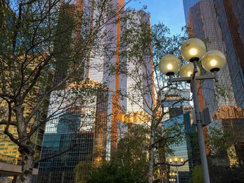 Low angle view of illuminated street light against sky