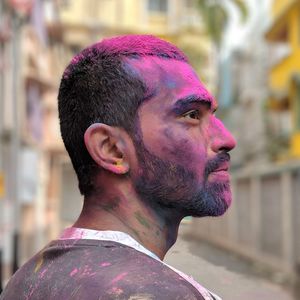 Close-up of young man covered in powder paint