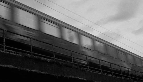 Low angle view of train against sky in city
