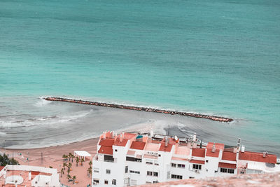 High angle view of buildings by sea 