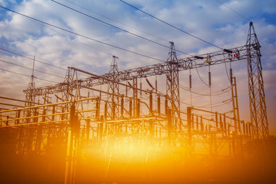 Electricity pylon against sky during sunset