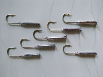 Close up of fishing hooks on marble floor