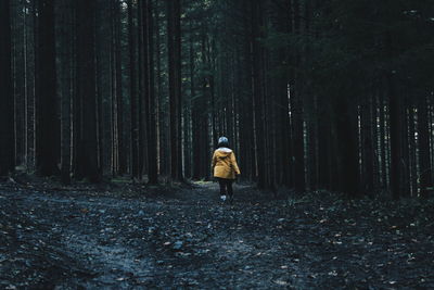 Full length of woman walking in forest