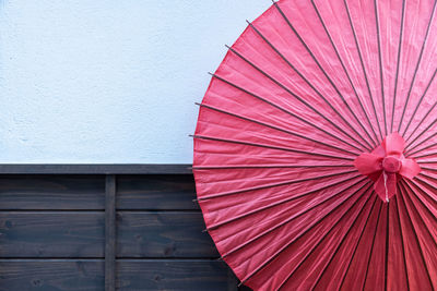 Low angle view of umbrella against wall