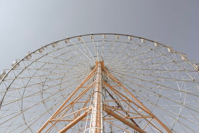 Low angle view of ferris wheel against sky