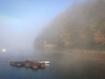 Ship in water against sky during foggy weather