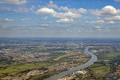 High angle view of river and cityscape against sky