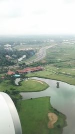 Aerial view of river amidst field against sky