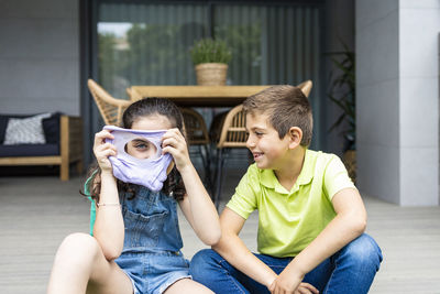 Two kids playing with a slime at home