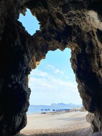 Rock formations by sea against sky