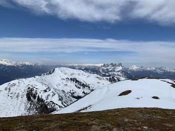 Scenic view of snowcapped mountains against sky