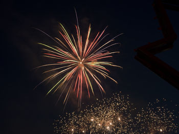 Low angle view of firework display at night