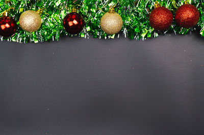 Close-up of christmas decorations hanging over white background