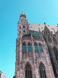 Low angle view of building against clear blue sky