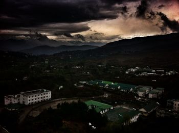 Aerial view of town against cloudy sky