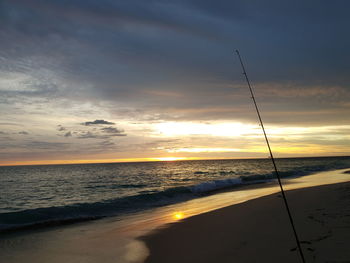 Scenic view of beach against sky during sunset