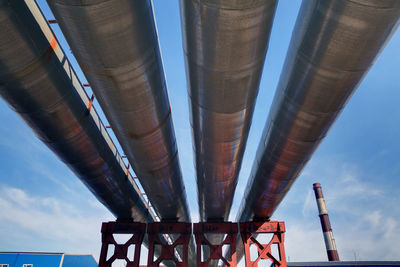 Low angle view of industry against sky