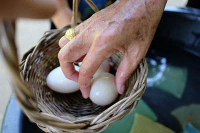 Close-up of hand holding ice cream in basket