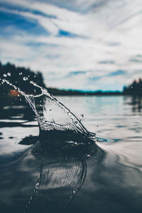 Close-up of water splashing against sky