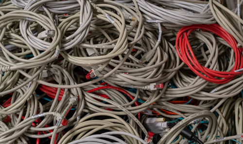 Old it network cables and power cables stored in a lattice box for disposal