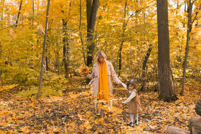 Rear view of woman standing in forest