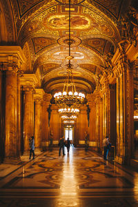 People walking in illuminated building