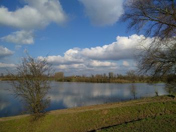 Scenic view of lake against cloudy sky