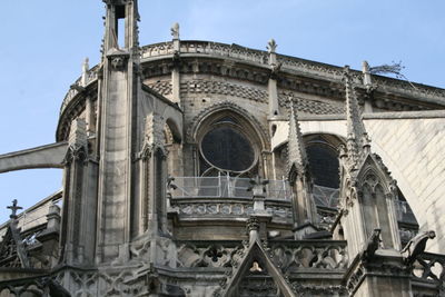 Low angle view of old notre dame against sky