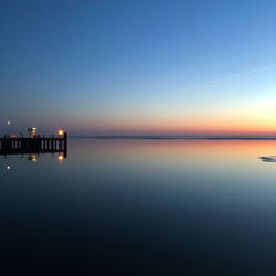 Scenic view of sea against clear sky during sunset