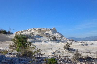 Scenic view of desert against clear blue sky