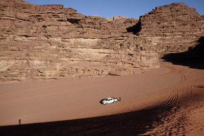 High angle view of off-road vehicle at desert against mountains