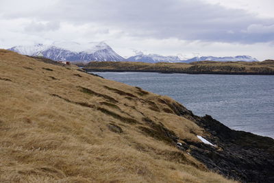 Scenic view of sea and mountains against sky