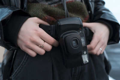 Midsection of woman photographing