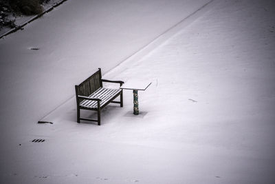 Empty road against snow covered wall