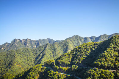 Scenic view of mountains against clear blue sky