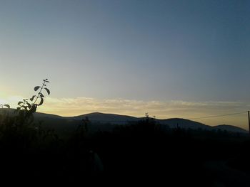 Silhouette of landscape against clear sky