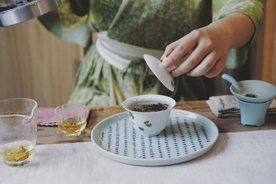 Man holding coffee cup on table