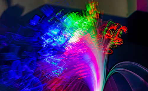 Close-up of illuminated light painting against black background